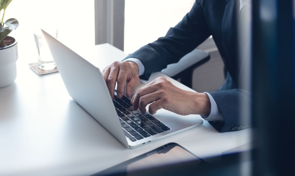 a person typing on a laptop