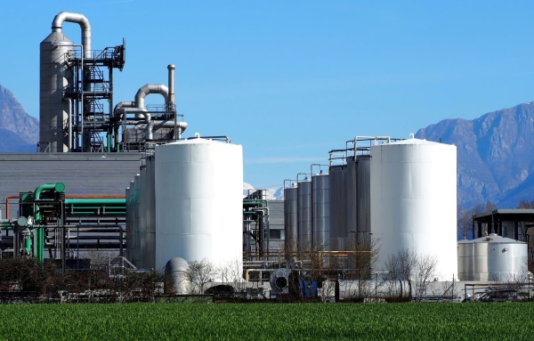 a large white tanks in a field