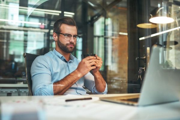 a person holding a cup of coffee