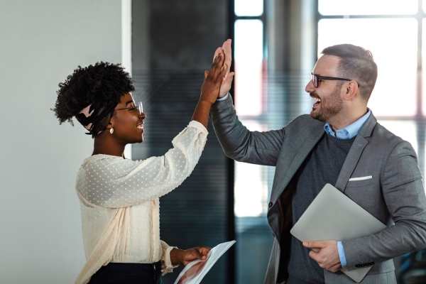 a person and person giving each other a high five