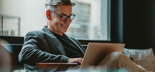 a person sitting at a table using a laptop