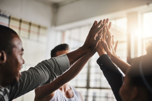 a group of people giving each other high five